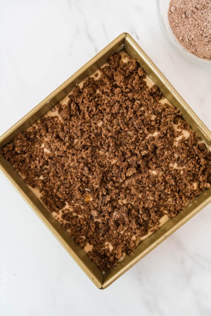 gold baking pan with coffee cake and crumb topping