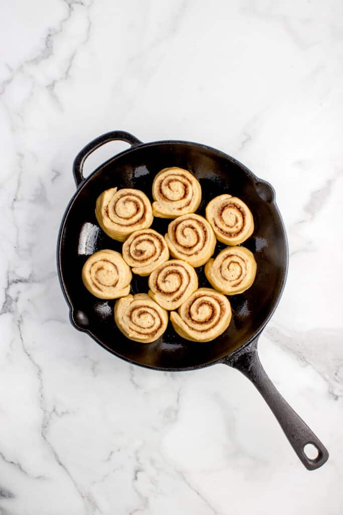cast iron skillet with cut rolls