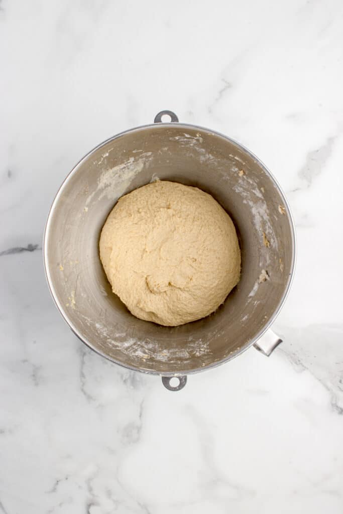 metal mixing bowl with dough for sourdough pumpkin cinnamon rolls