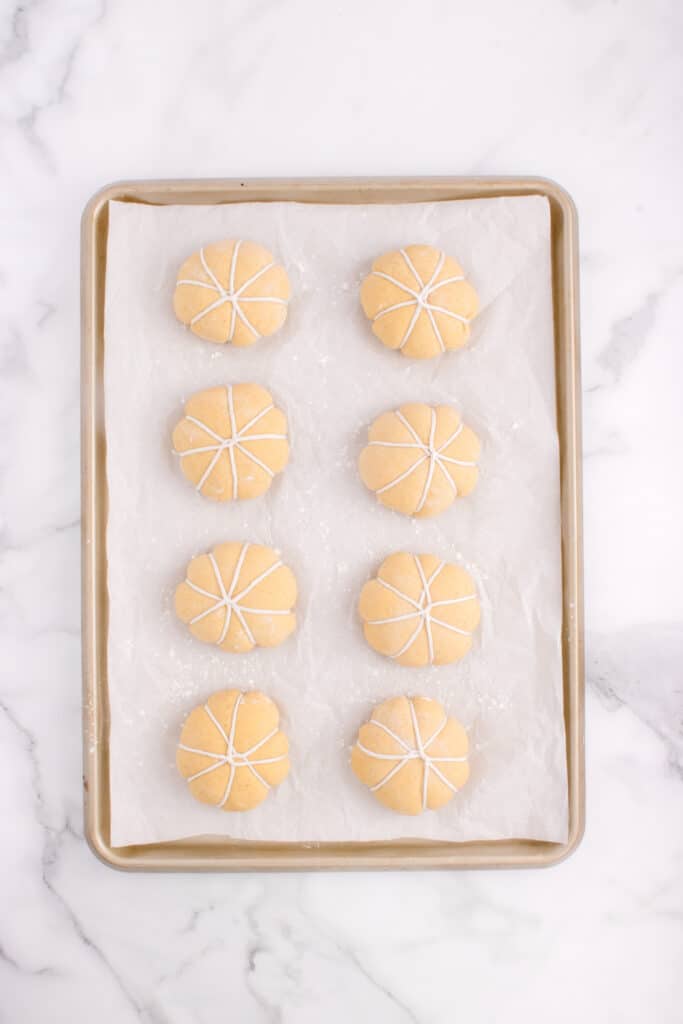 baking tray with sourdough pumpkin rolls wrapped in string