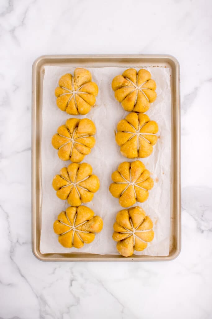 baked sourdough pumpkin rolls on baking tray