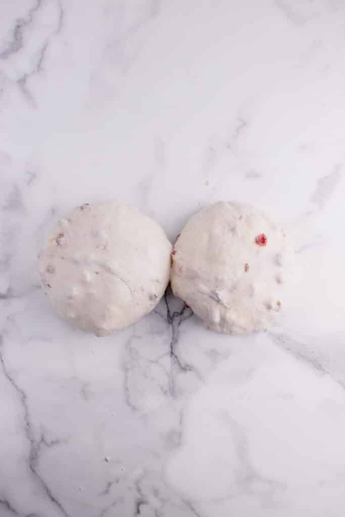 two round balls of sourdough bread dough with cranberries