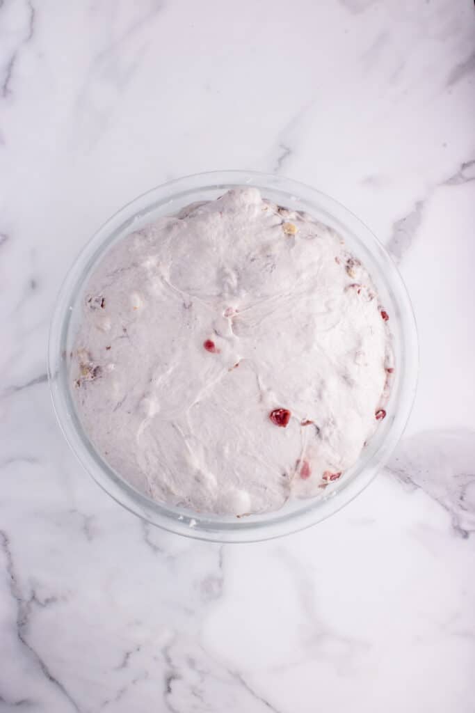glass bowl with sourdough walnut cranberry dough after bulk fermentation