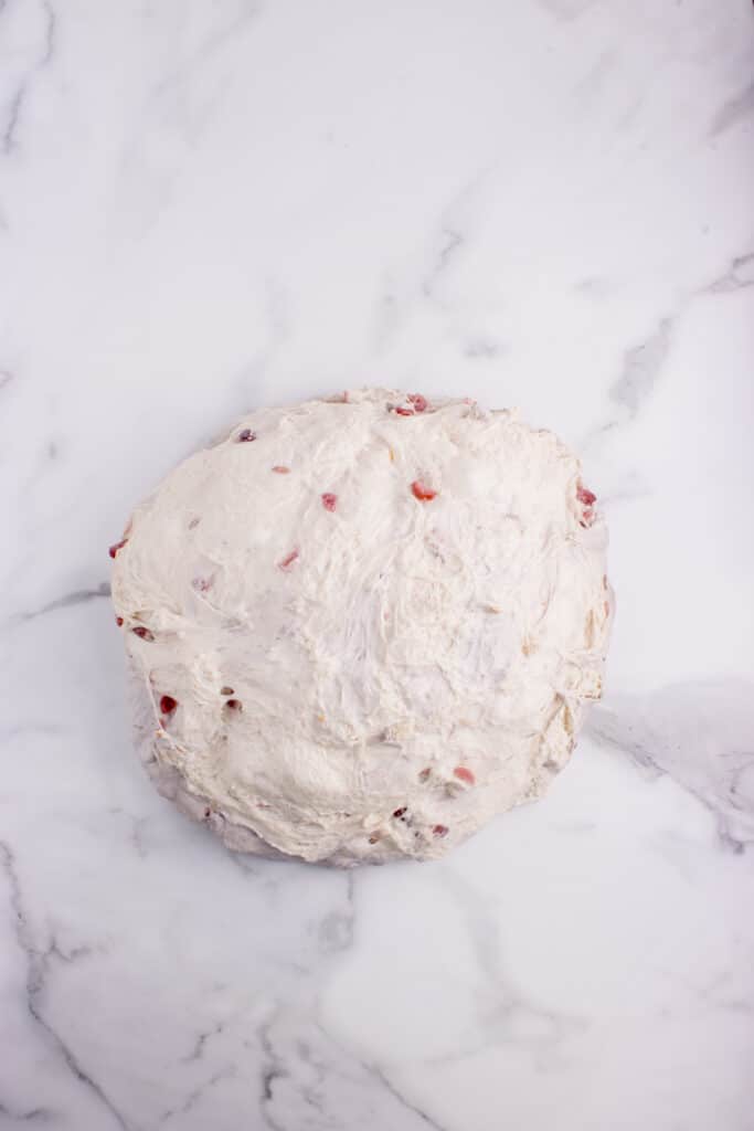 sourdough bread dough with cranberries and walnuts turned out onto counter