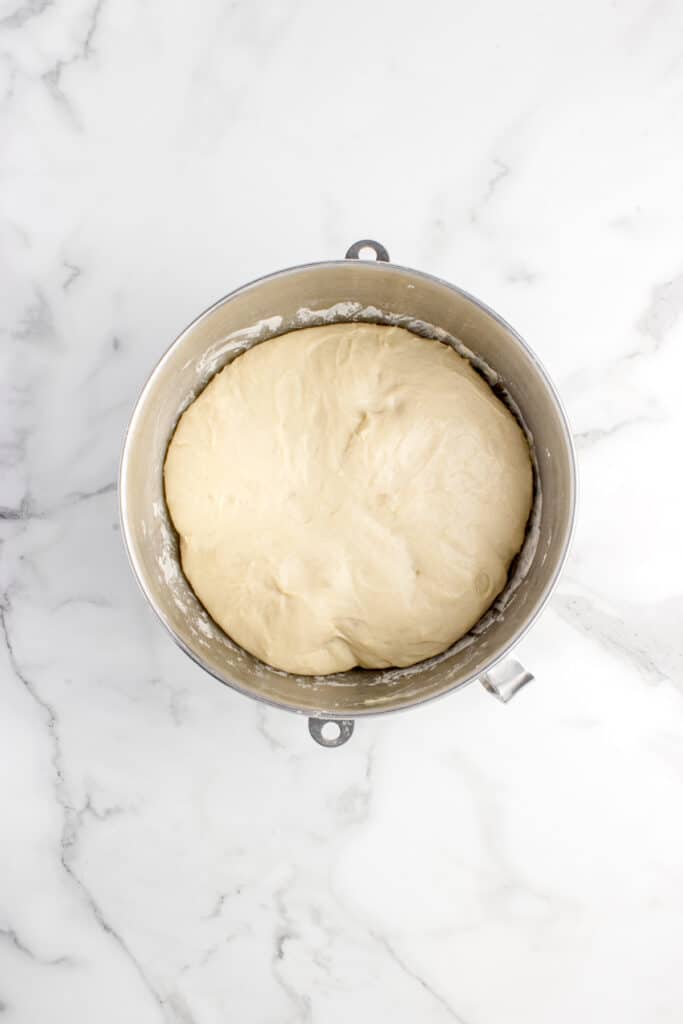 metal mixing bowl with sourdough donut dough after doubled in size