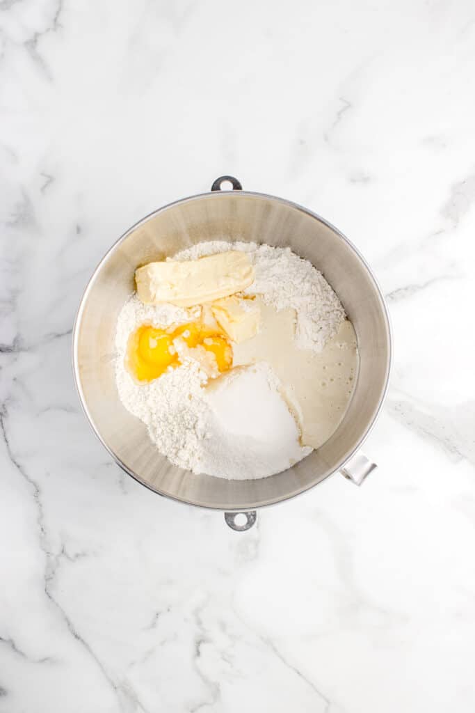 metal mixing bowl with ingredients for sourdough donuts