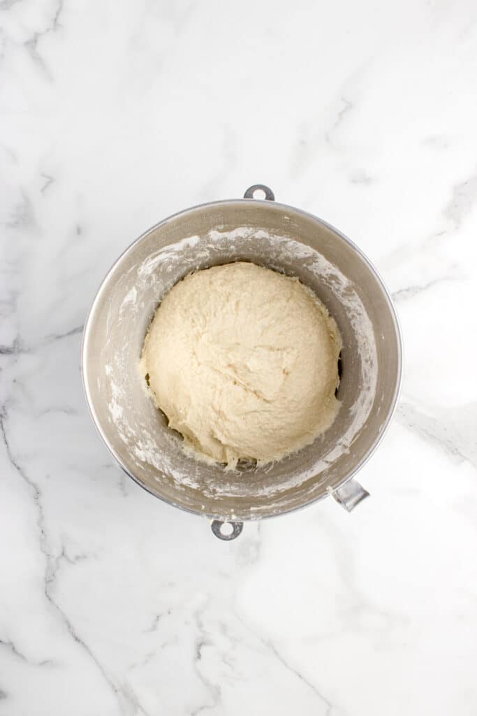dough for sourdough donuts mixed in metal mixing bowl