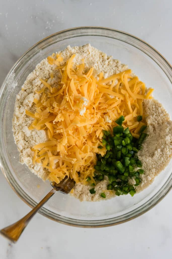 glass bowl with ingredients for sourdough cheddar jalapeño biscuits