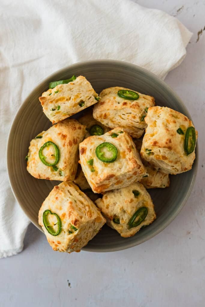overhead view of grey bowl filled with sourdough jalapeño cheddar biscuits