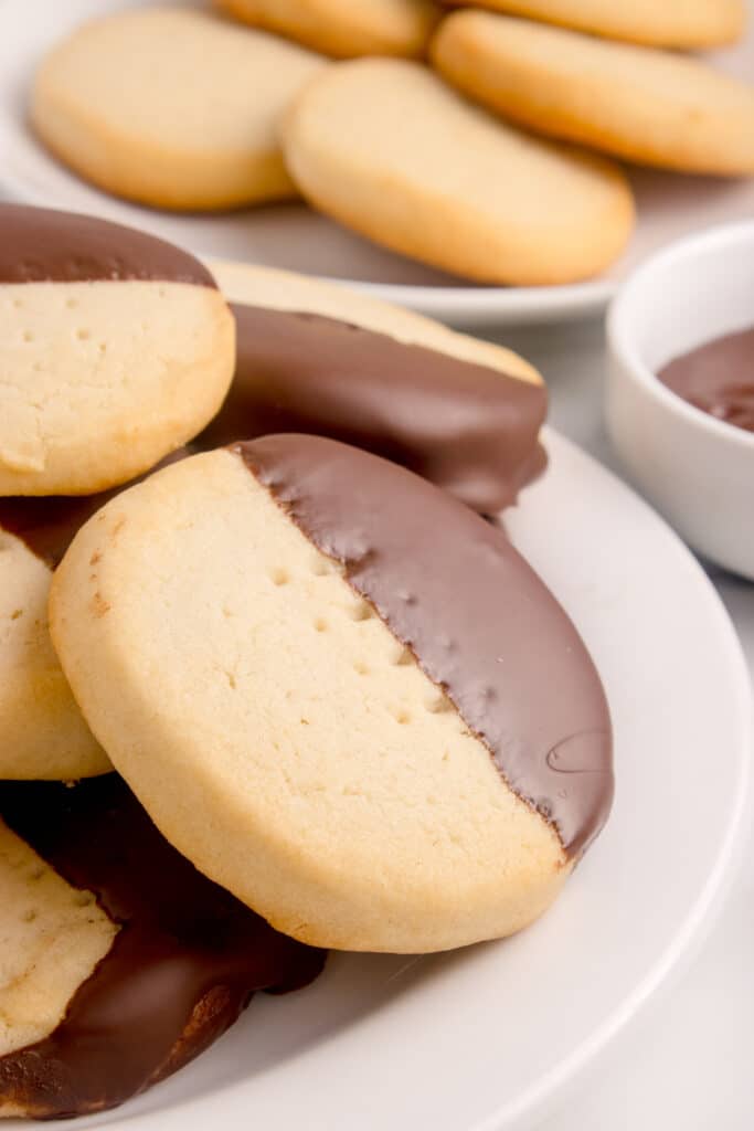 sourdough shortbread cookies dipped in chocolate on white plate
