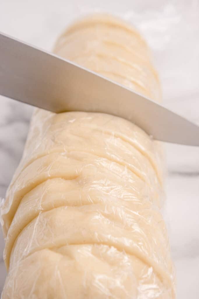 slicing dough into cookies